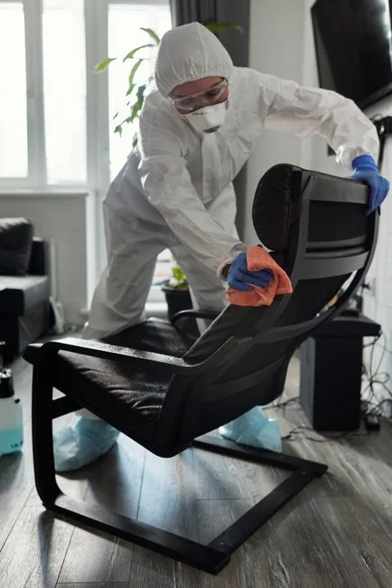 Side view of young ethnic male in uniform cleaning floor with mop while working in retro styled restaurant